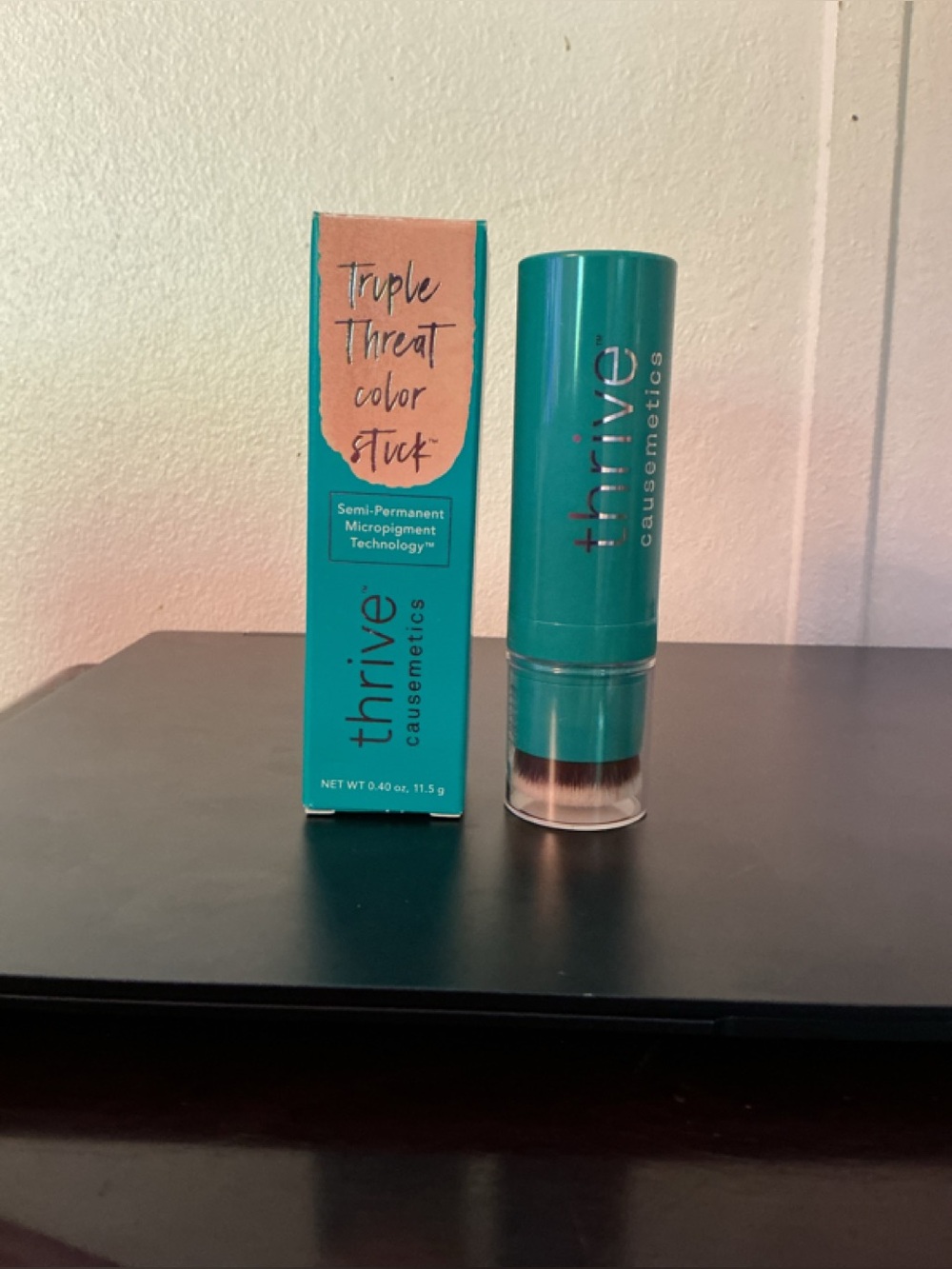 thrive causemetics Triple Threat Color Stick in Teal Packaging with gold shimmer